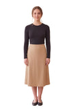 Black long-sleeve layering shell on a model with a beige skirt