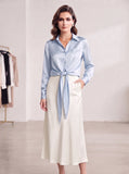 Light-blue satin blouse styled with a visible front tie