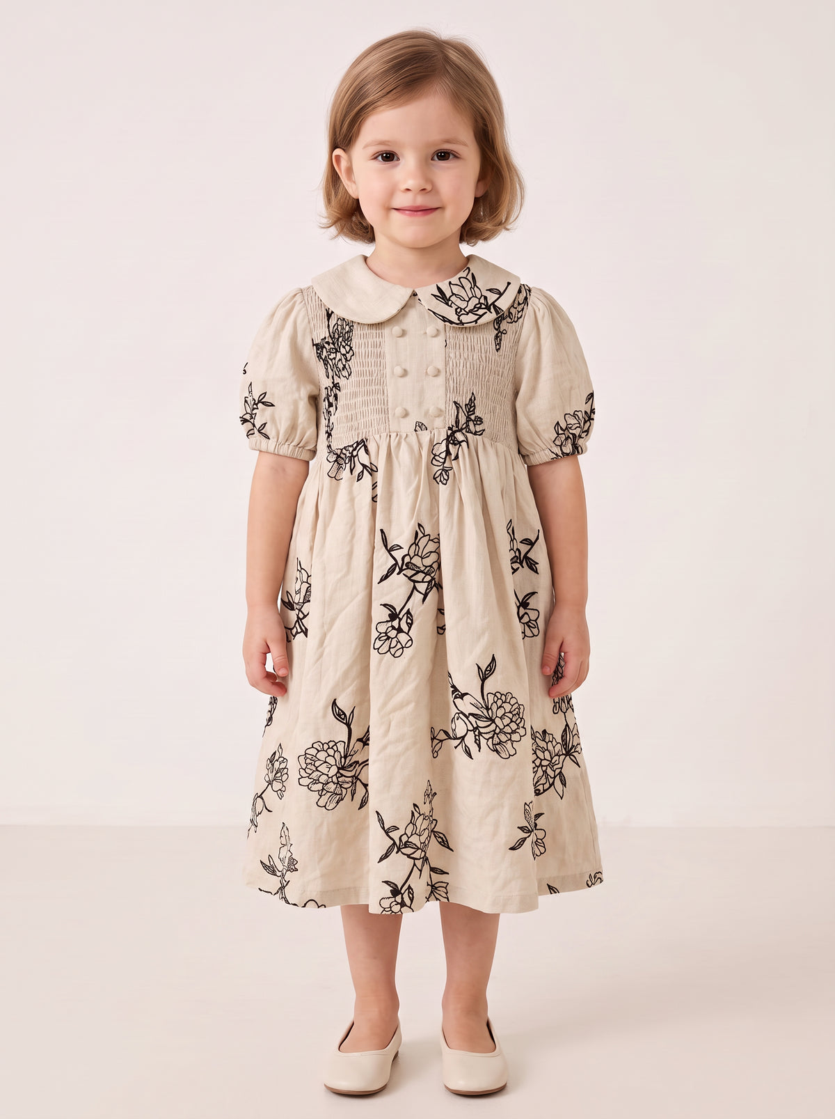 Beige floral smocked dress on a girl, knee-covering skirt