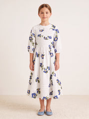 Blue floral pintuck dress on a girl, knee-covering skirt