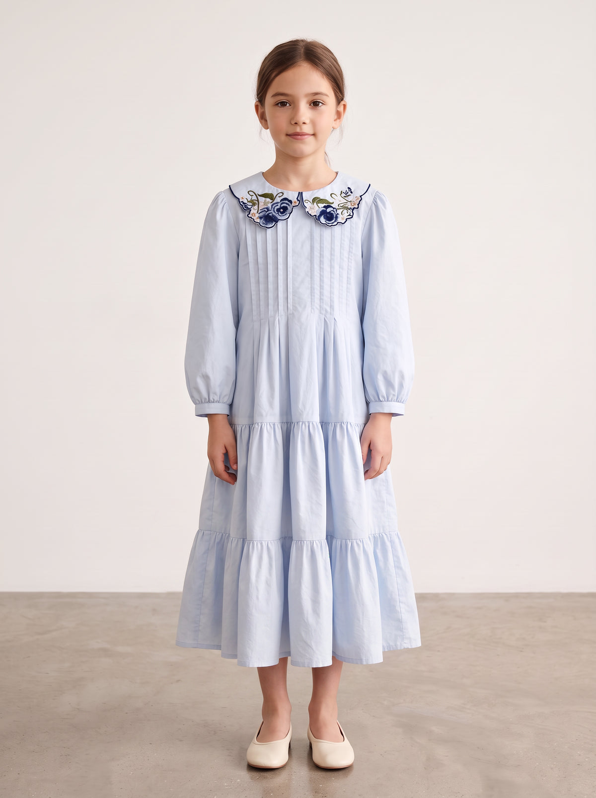Light blue floral-collar pintuck dress on a girl, knee-covering skirt