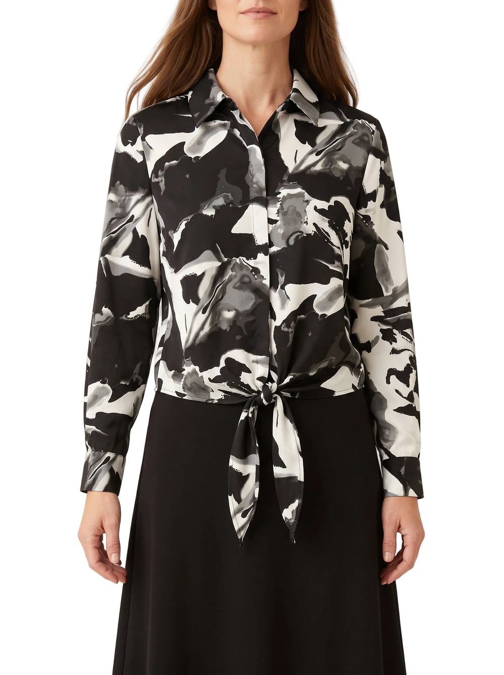 Black and white abstract-print tie-front blouse with pointed collar and long sleeves on a model