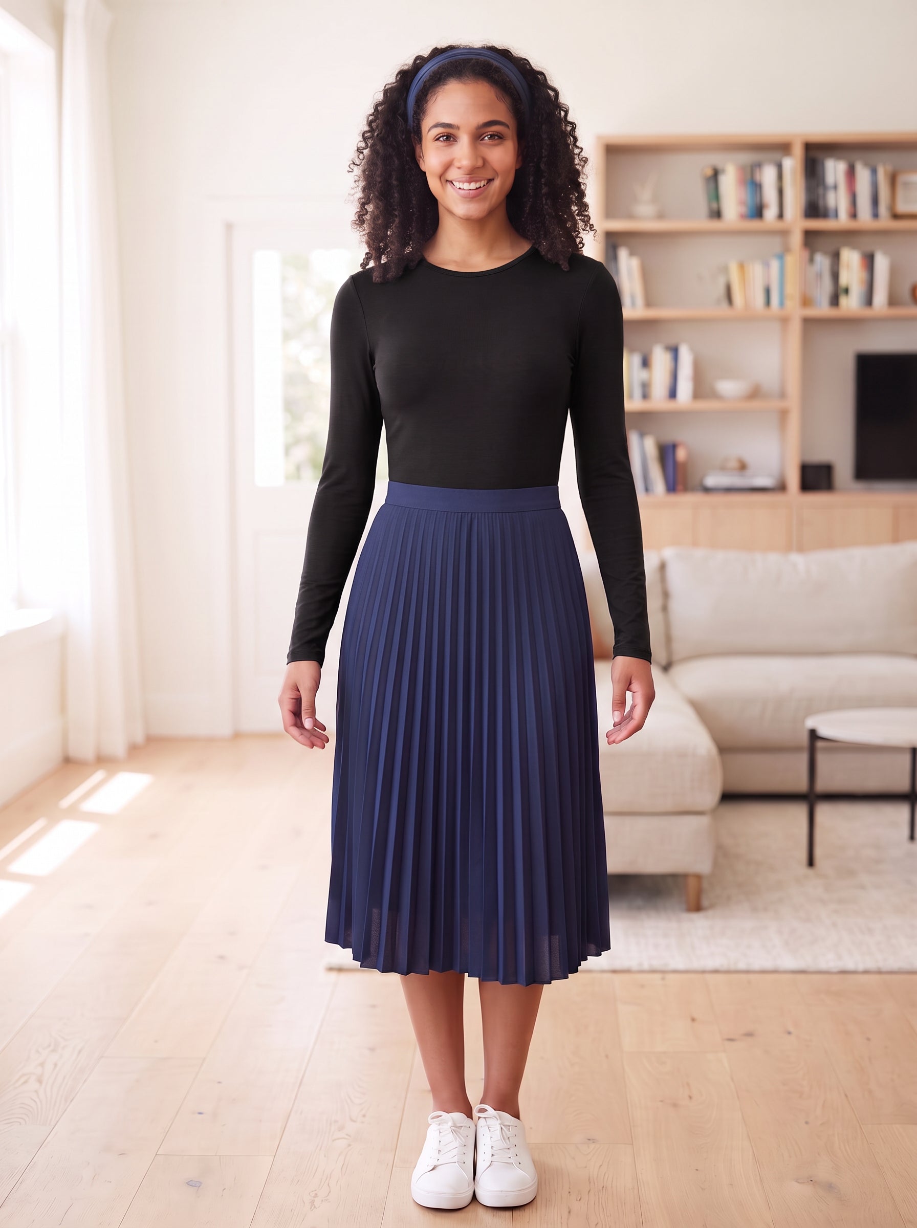 Black fitted long-sleeve layering shell, Style 6657-23, tucked into navy pleated skirt