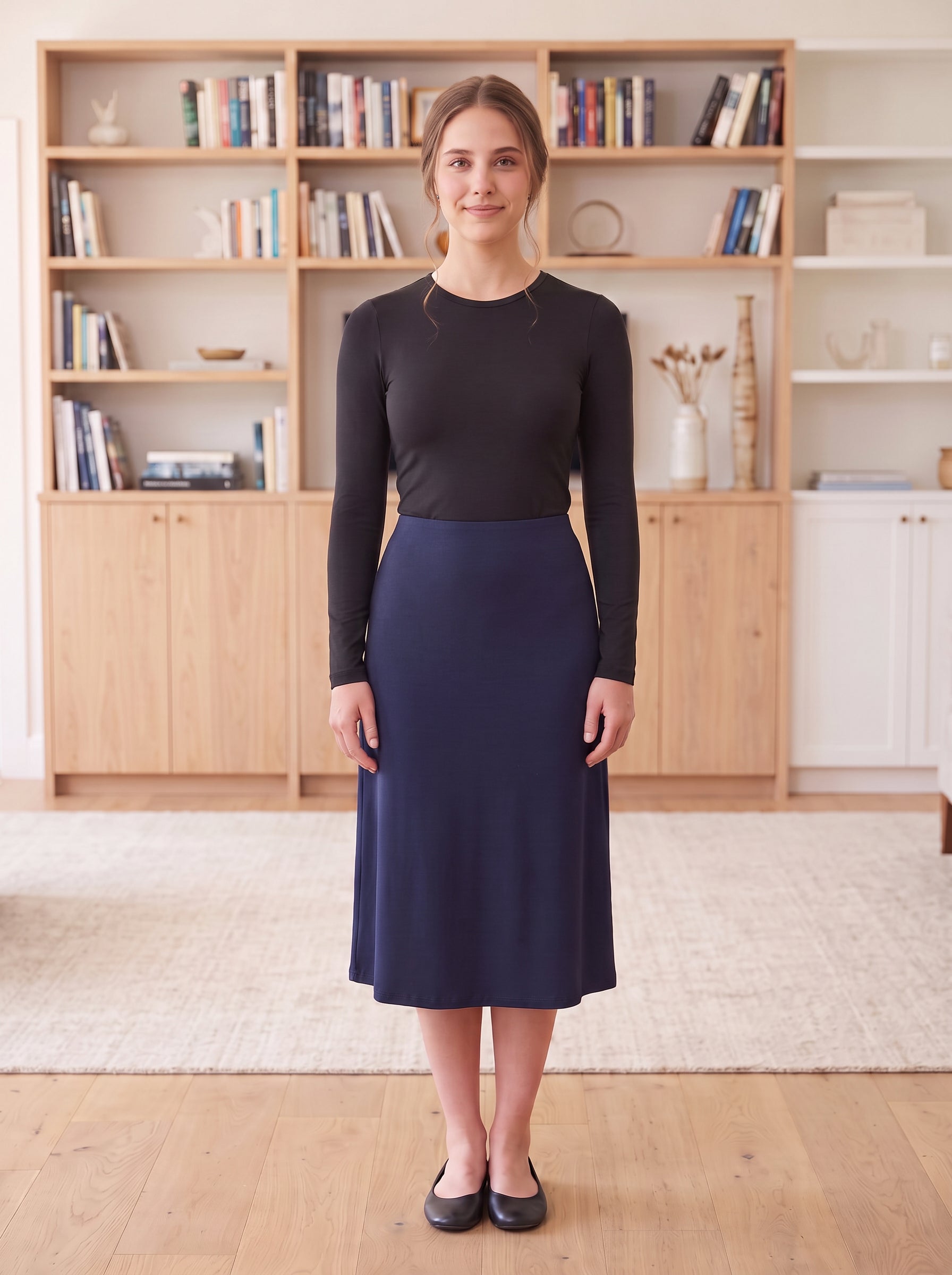 Black fitted long-sleeve layering shell, Style 3327-1, tucked into navy skirt