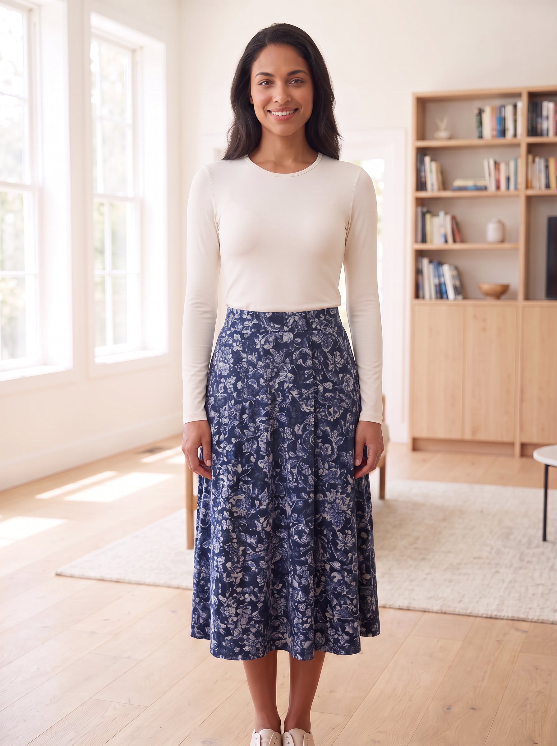 Off-white fitted long-sleeve layering shell, Style 6657, tucked into navy floral skirt