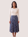 Off-white long-sleeve layering shell on a model with a blue floral skirt